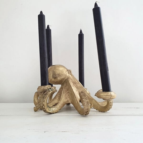 Side view of octopus candlestick with black candles